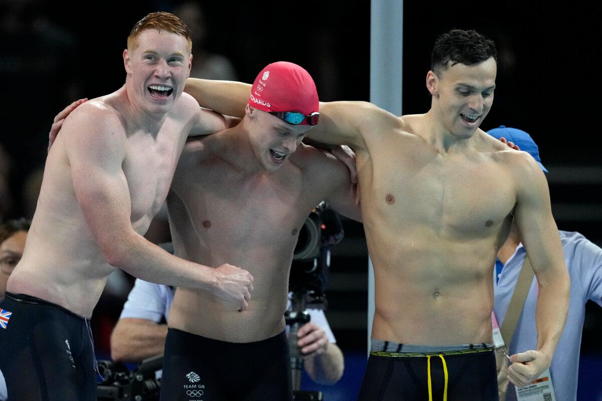 Britain's men's 4x200-meter freestyle relay team celebrates after winning in Nanterre, France, on July 30, 2024. (Ashley Landis/AP Photo)
