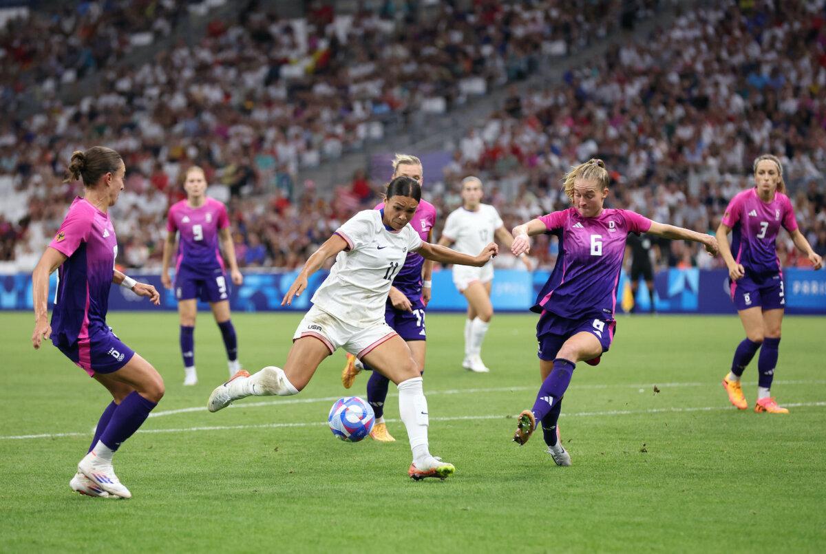 Sophia Smith #11 of Team United States holds off Janina Minge #6 of Team Germany (R) during the Women's group B match between United States and Germany during the Olympic Games Paris 2024 at Stade de Marseille in Marseille, France on July 28, 2024. (Alex Livesey/Getty Images)