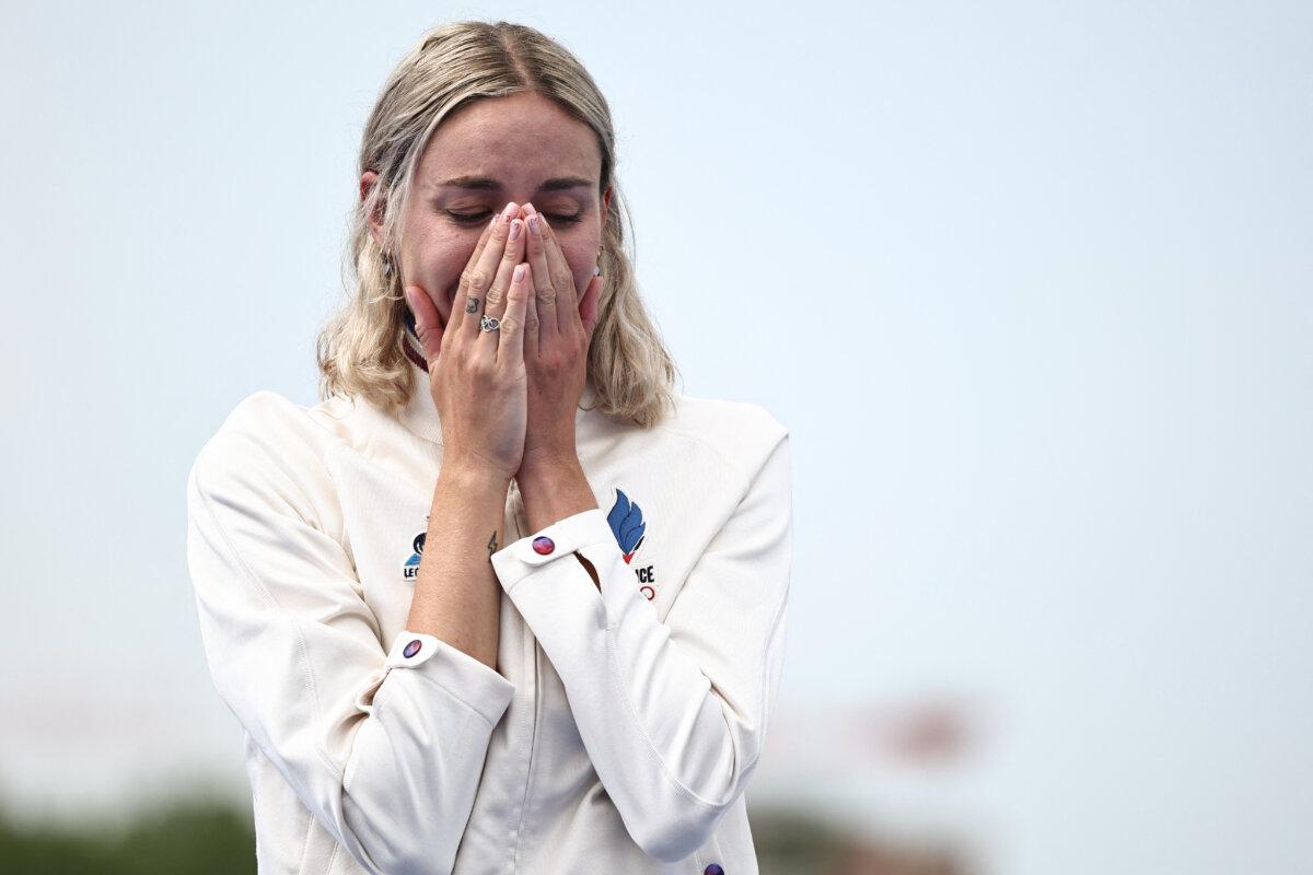 Gold medallist France's Cassandre Beaugrand reacts on the podium during the victory ceremony for the women's individual triathlon at the Paris 2024 Olympic Games in central Paris on July 31, 2024. (Anne-Christine Poujoulat/AFP via Getty Images)