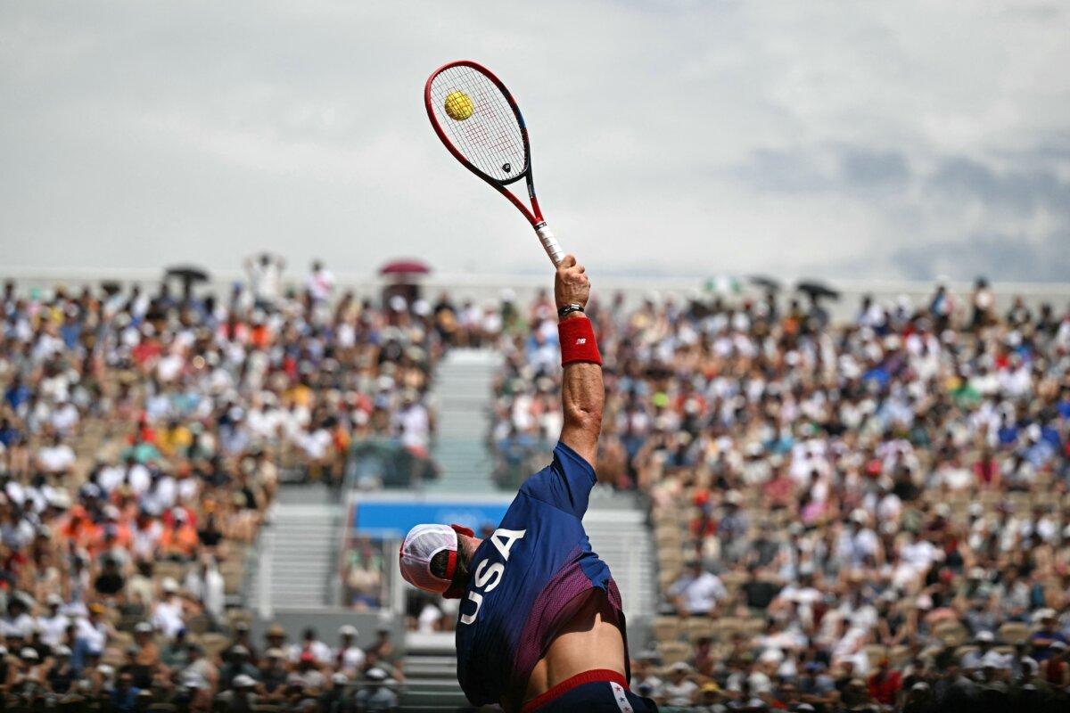Team USA's Tommy Paul serves to France's Corentin Moutet during their men's singles third round tennis match on Court Suzanne-Lenglen at the Roland-Garros Stadium during the Paris 2024 Olympic Games, in Paris on July 31, 2024. (Patricia De Melo Moreira/ AFP via Getty Images)
