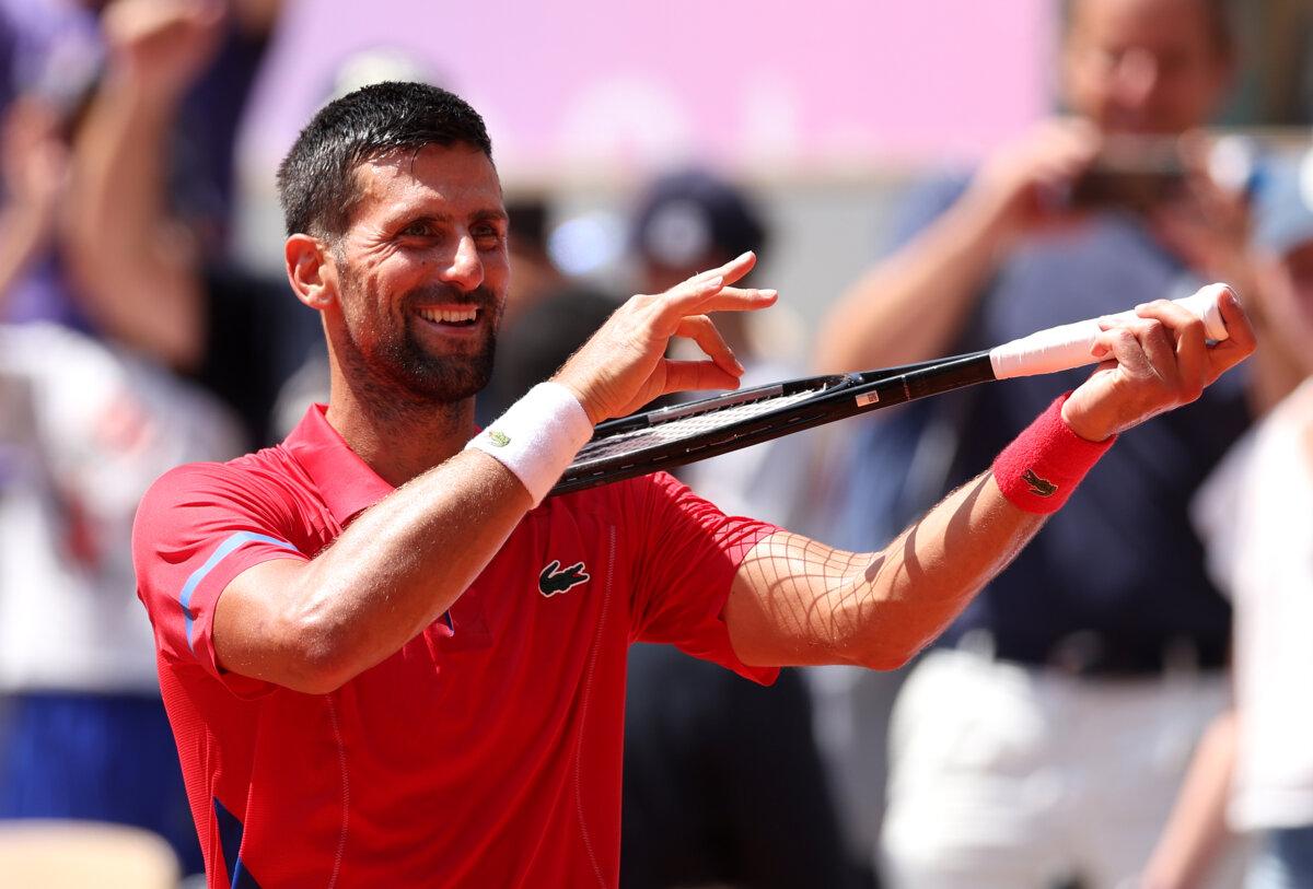 Novak Djokovic of Team Serbia celebrates winning match point against Dominik Koepfer of Team Germany during the Men's Singles Third Round match on day five of the Olympic Games Paris 2024 at Roland Garros in Paris on July 31, 2024. (Julian Finney/Getty Images)