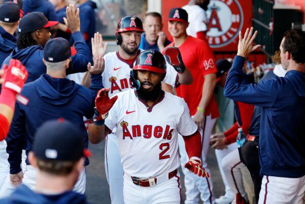 Luis Rengifo (2) and Nolan Schanuel (18) of the Los Angeles Angels are congratulated after they scored on a double by Taylor Ward (3) against starting pitcher Cal Quantrill (47) of the Colorado Rockies during the first inning in Anaheim, Calif., on July 30, 2024. (Kevork Djansezian/Getty Images)