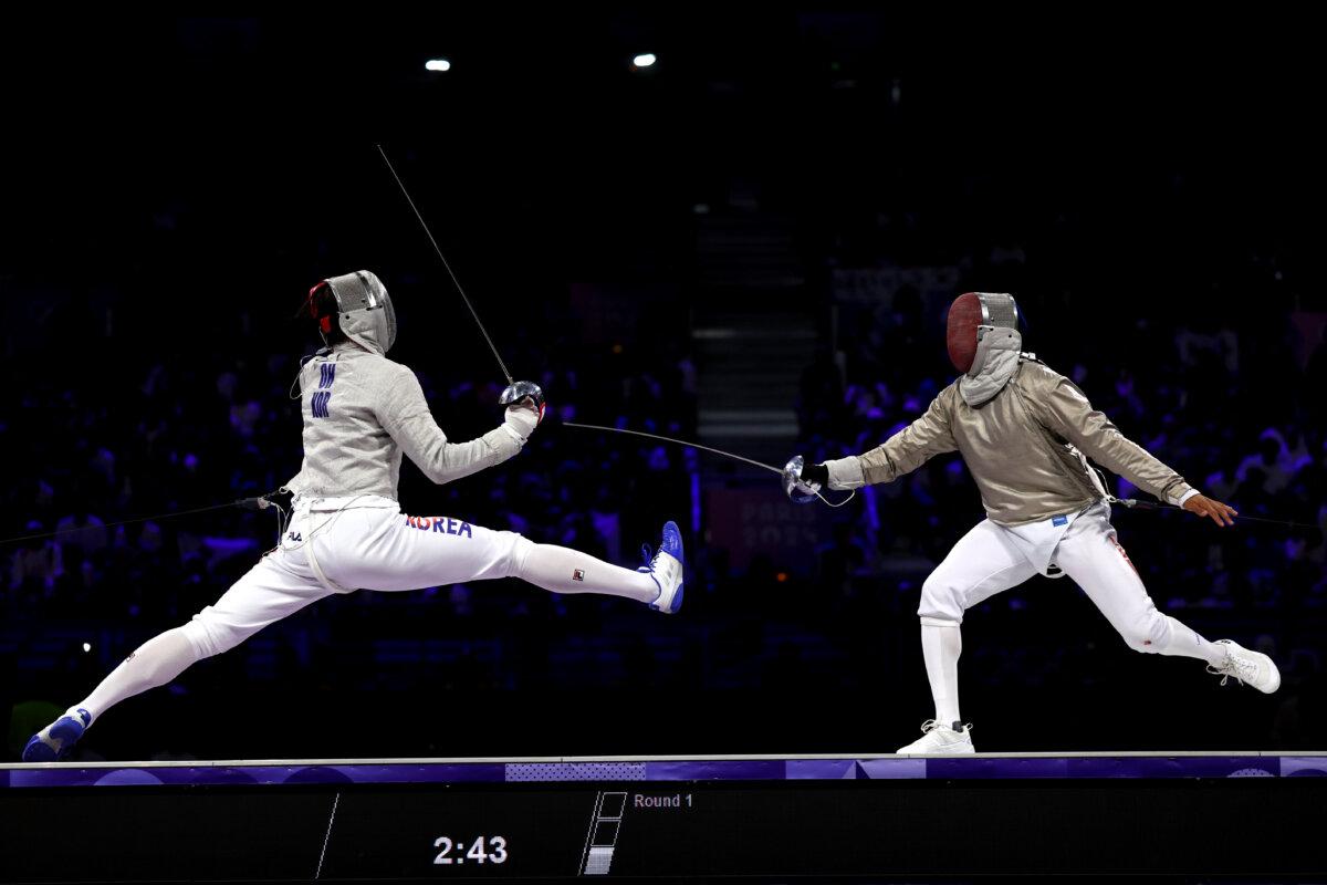 Sanguk Oh of Team Republic of Korea competes with Fares Ferjani of Team Tunisia Men's Sabre Individual Table of 32 match between Sanguk Oh of Team Republic of Korea and Fares Ferjani of Team Tunisia on day one of the Olympic Games Paris 2024 at Grand Palais in Paris, on July 27, 2024. (Patrick Smith/Getty Images)