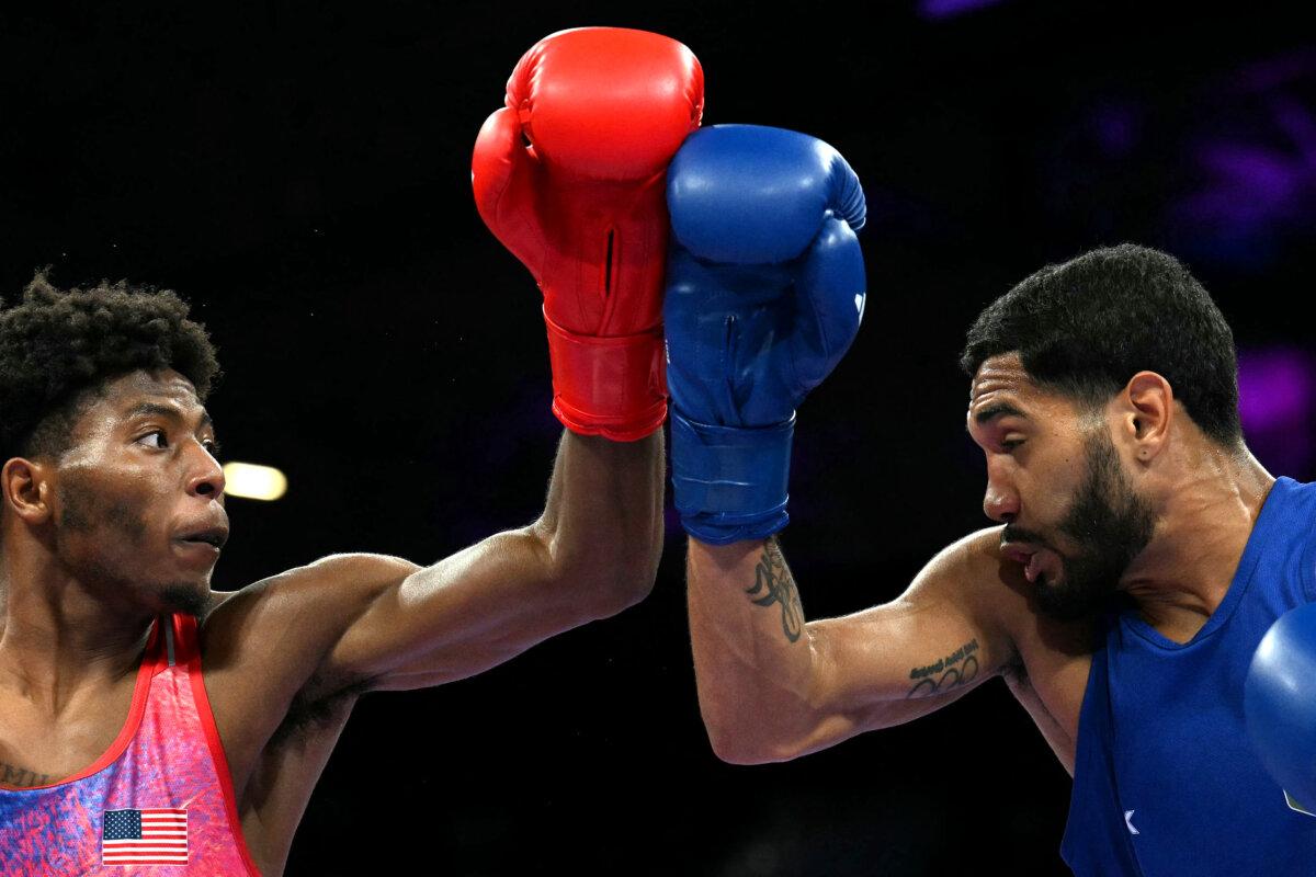 US' Jahmal Harvey (in red) fights against Brazil's Luiz Gabriel Oliveira in the men's 57kg preliminaries round of 16 boxing match during the Paris 2024 Olympic Games at the North Paris Arena, in Villepinte on July 31, 2024. (Mohd Rasfan/ AFP via Getty Images)