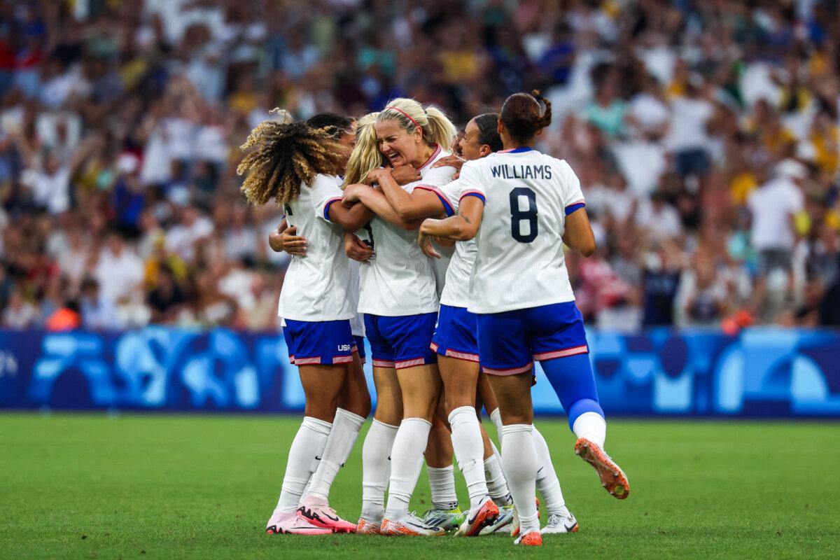 US' midfielder #03 Korbin Albert celebrates with teammates after scoring her team's second goal during the women's group B football match between Australia and the USA of the Paris 2024 Olympic Games at the Marseille Stadium in Marseille on July 31, 2024. (Pascal Guyot/ AFP via Getty Images)