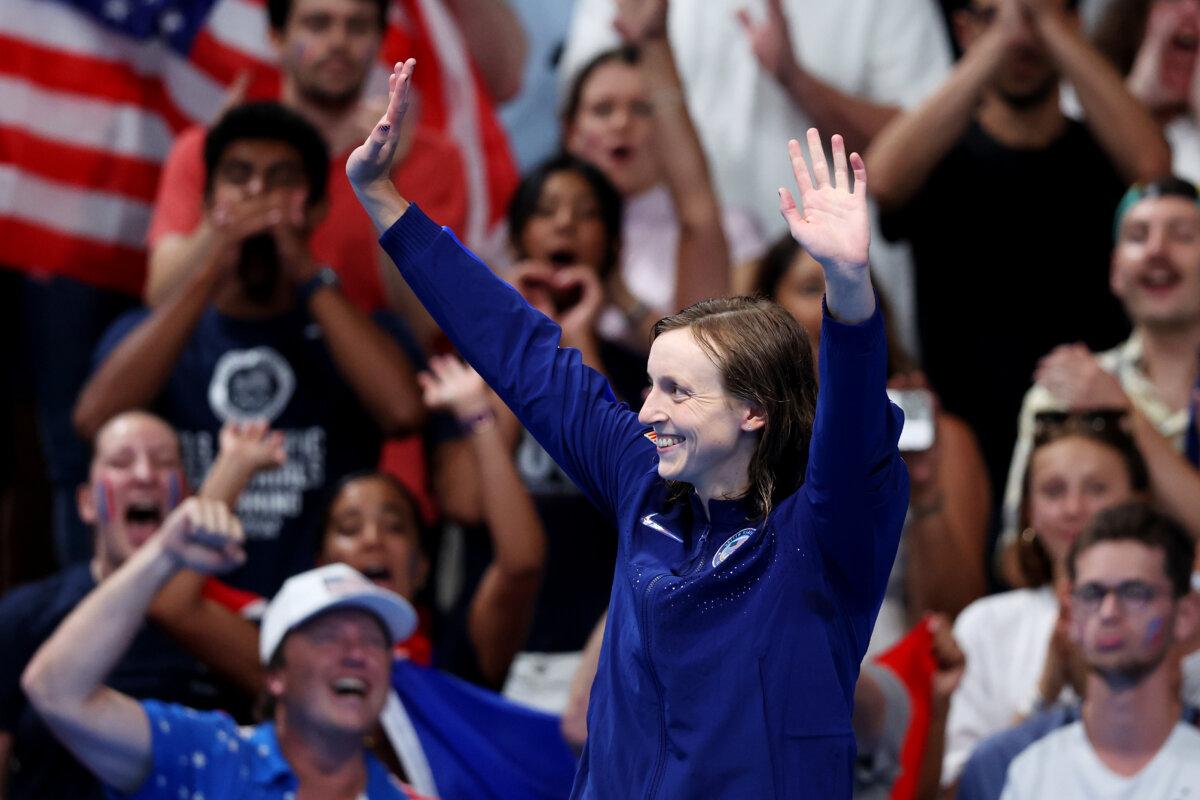 Gold Medalist Katie Ledecky of Team United States celebrates on the podium during the Swimming medal ceremony after the Women's 1500-Meter Freestyle Final on day five of the Olympic Games Paris 2024 at Paris La Defense Arena in Nanterre, France, on July 31, 2024. (Sarah Stier/Getty Images)