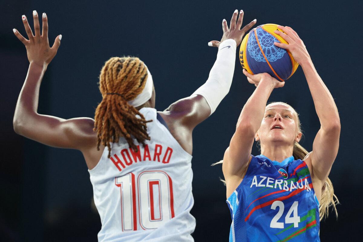 US' #10 Rhyne Howard (L) tries to block Azerbaijan's #24 Alexandra Mollenhauer in the women's pool round 3x3 basketball game between the USA and Azerbaijan during the Paris 2024 Olympic Games at La Concorde in Paris on July 31, 2024. (David Gray/ AFP via Getty Images)