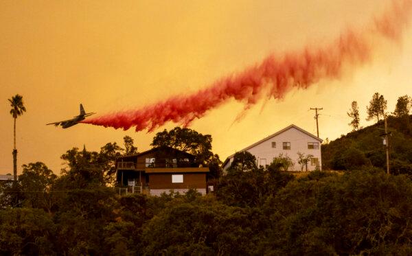 California’s 10 Largest Wildfires and What Caused Them | USNN World News An airplane drops fire retardant over homes as flames from the LNU Lightning Complex fire rage through in the Spanish Flat area of Napa, Calif., on Aug. 18, 2020. (Josh Edelson/AFP via Getty Images)