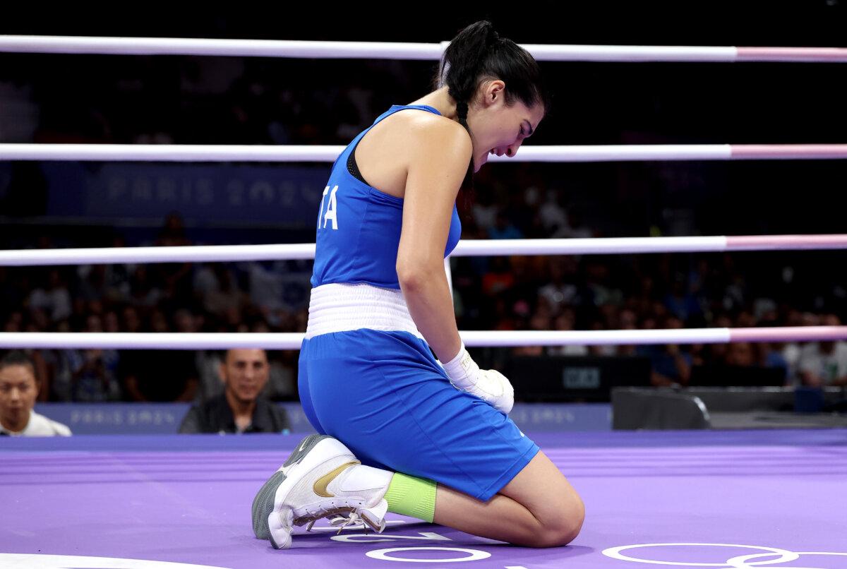 Angela Carini of Team Italy reacts after abandoning the Women's 66kg preliminary round match against Imane Khelif of Team Algeria in a first-round boxing match of the Olympic Games Paris 2024 at North Paris Arena in Paris on Aug. 1, 2024. (Richard Pelham/Getty Images)