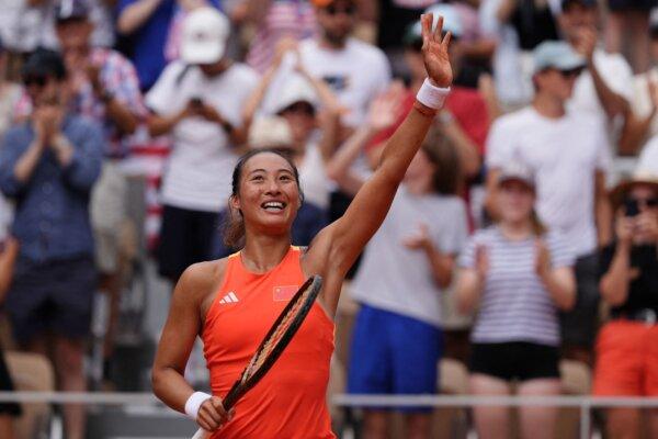 China's Zheng Qinwen celebrates after beating Poland's Iga Swiatek in their women's singles semifinal tennis match in Paris on Aug. 1, 2024. (Dimitar Dilkoff/AFP via Getty Images)
