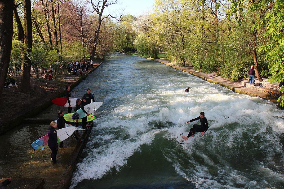 Surfers ride the man-made waves on the Eisbach river. (Werner Boehm/München Tourismus)