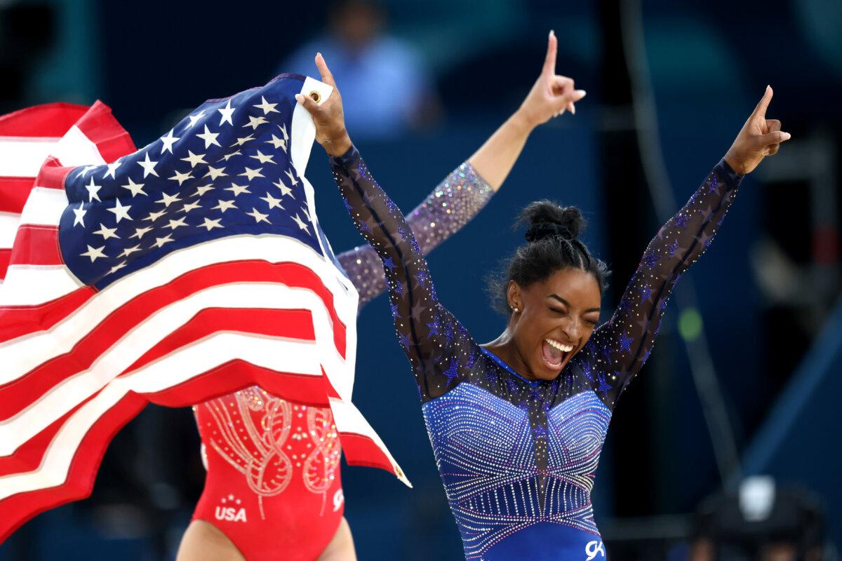 Gold medalist Simone Biles and Bronze medalist Sunisa Lee of Team United States celebrate with the American flag after competing in the Artistic Gymnastics Women's All-Around Final on day six of the Olympic Games Paris 2024 at Bercy Arena in Paris on August 1, 2024. (Pascal Le Segretain/Getty Images)