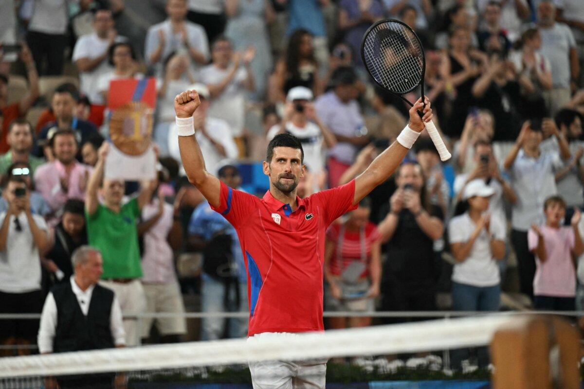 Serbia's Novak Djokovic celebrates after his win over Greece's Stefanos Tsitsipas in their men's singles quarter-final tennis match on Court Philippe-Chatrier at the Roland-Garros Stadium during the Paris 2024 Olympic Games, in Paris on August 1, 2024. (Patricia De Melo Moreira/ AFP via Getty Images)
