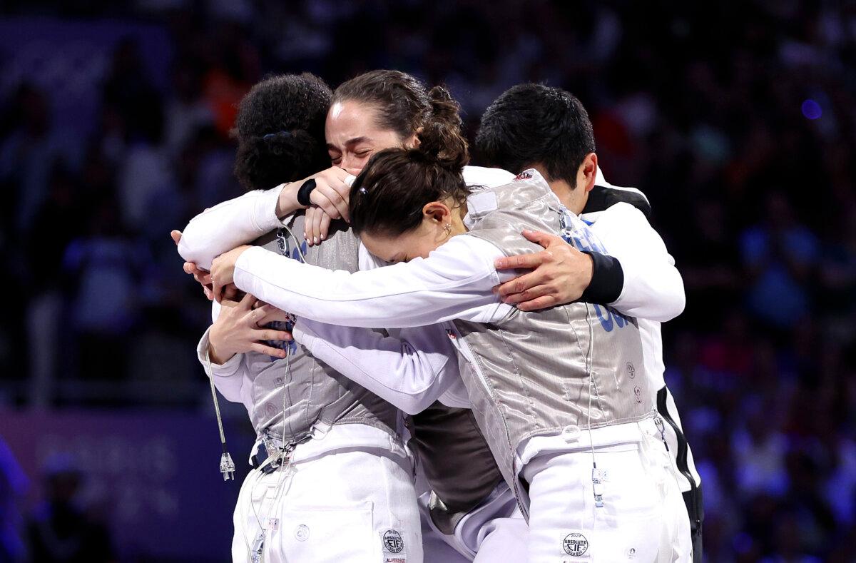 Jacqueline Dubrovich, Maia Weintraub, Lauren Scruggs, and Lee Kiefer Team United States celebrate winning against Team Italy during the Fencing Women's Foil Team Gold Medal match between Team Italy and Team United States on day six of the Olympic Games Paris 2024 at Grand Palais in Paris on August 1, 2024. (Clive Brunskill/Getty Images)