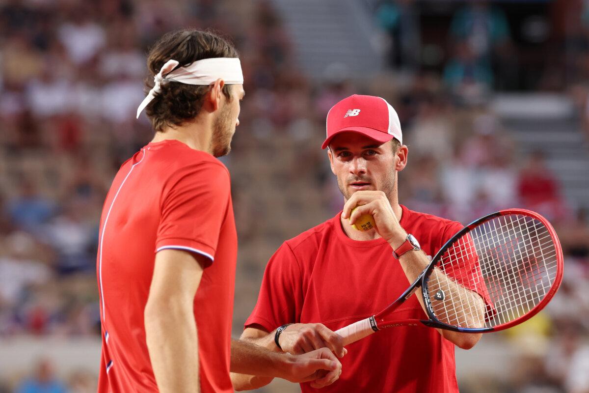 Tommy Paul of Team United States interacts with partner Taylor Fritz of Team United States against Daniel Evans of Team Great Britain and Andy Murray of Team Great Britain during the Men's Doubles Quarter-final match on day six of the Olympic Games Paris 2024 at Roland Garros in Paris on August 1, 2024. (Julian Finney/Getty Images)
