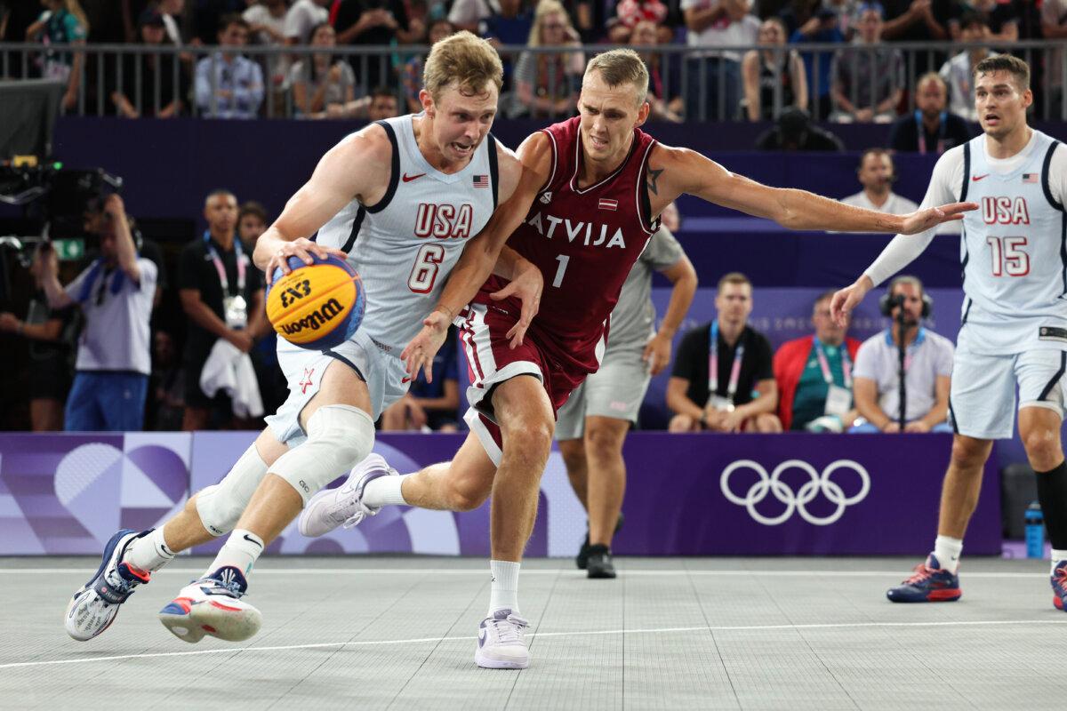 Canyon Barry #6 of Team United States drives past Nauris Miezis #1 of Team Latvia during a Men's 3x3 basketball pool round game between United States and Latvia on day six of the Olympic Games Paris 2024 at Esplanade Des Invalides in Paris on August 1, 2024. (Elsa/Getty Images)