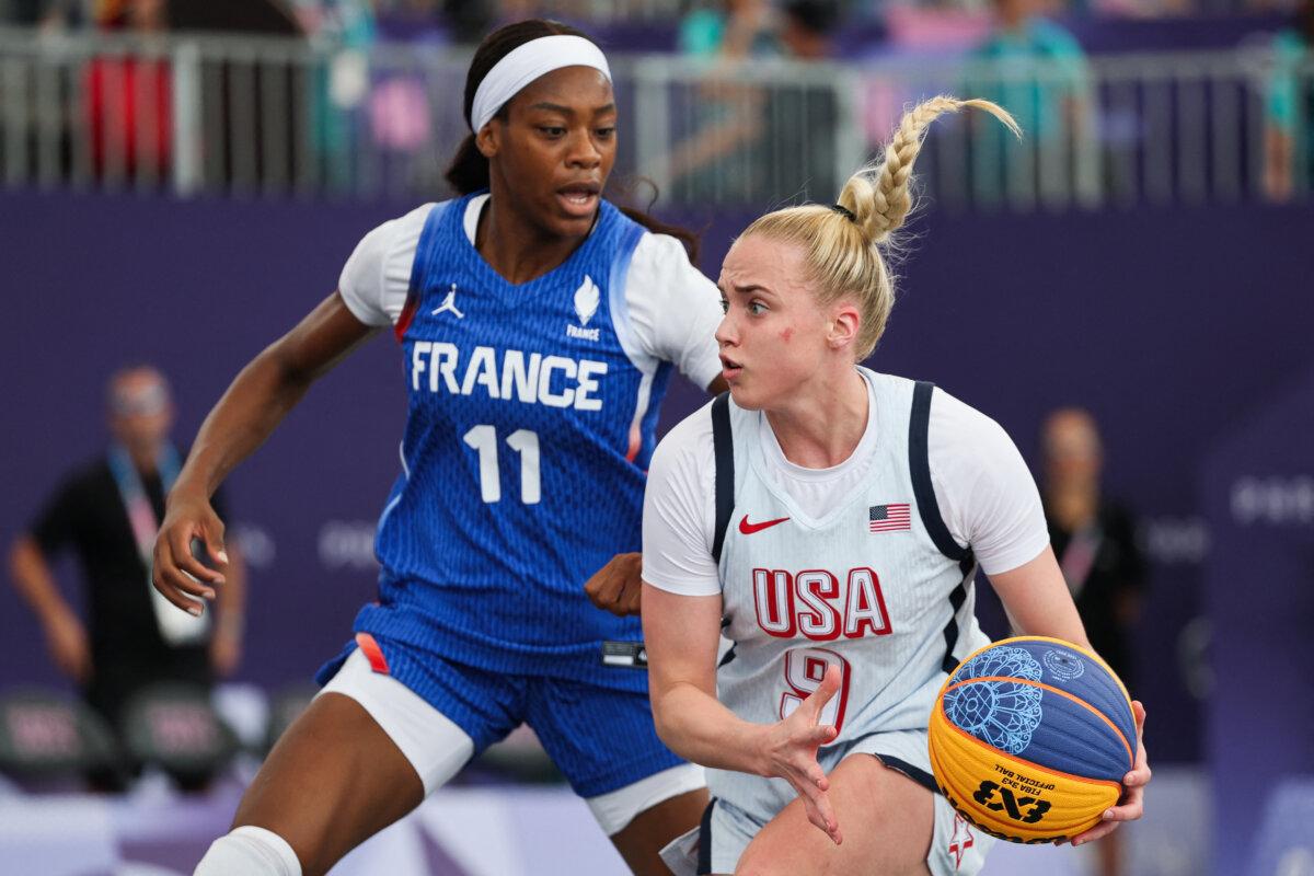 France's #11 Myriam Djekoundade fights for the ball with US' #09 Hailey van Lith in the women's pool round 3x3 basketball game between the USA and France during the Paris 2024 Olympic Games at La Concorde in Paris on August 2, 2024. (David Gray/ AFP via Getty Images)