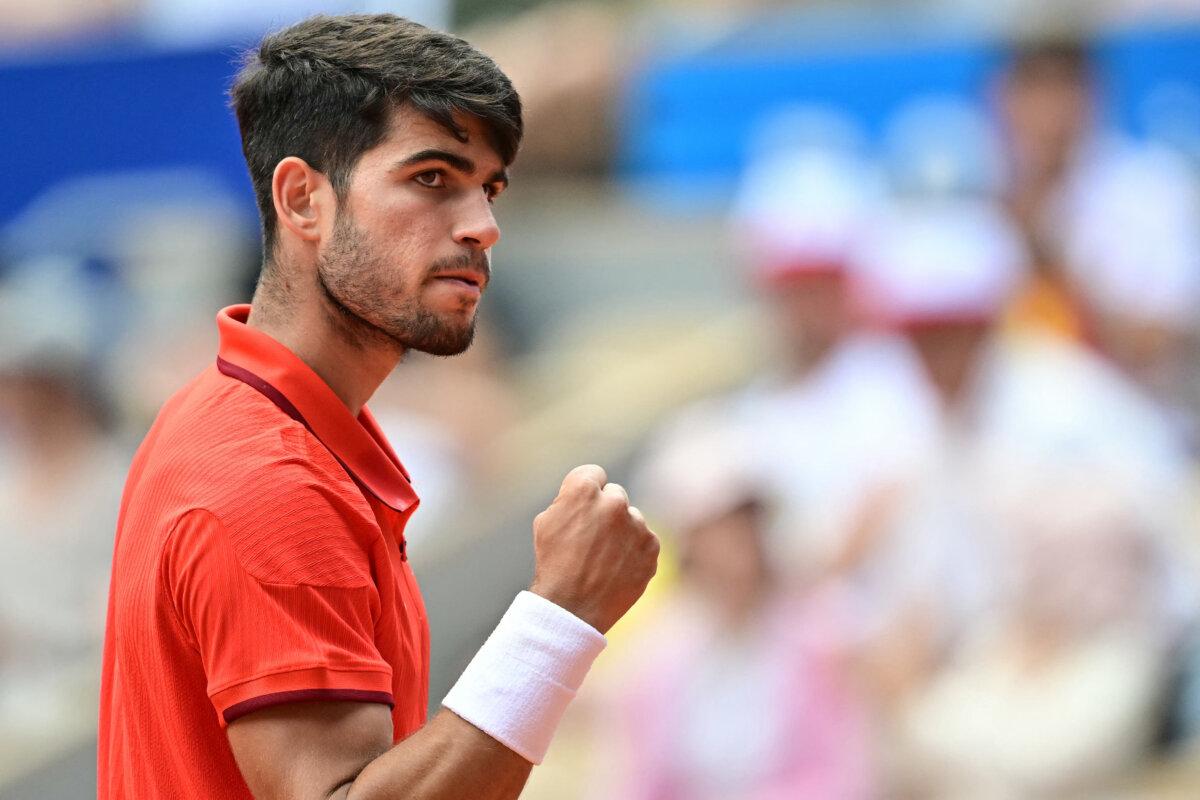 Spain's Carlos Alcaraz reacts while playing Canada's Felix Auger-Aliassime during their men's singles semi-final tennis match on Court Philippe-Chatrier at the Roland-Garros Stadium during the Paris 2024 Olympic Games, in Paris on August 2, 2024. (Miguel Medina/AFP via Getty Images)