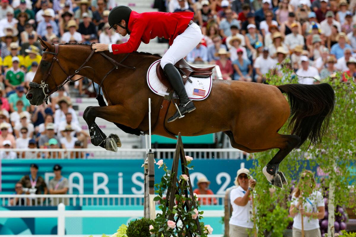 US' Karl Cook with horse Caracole De La Roque competes in the equestrian's jumping team final during the Paris 2024 Olympic Games at the Chateau de Versailles, in Versailles, in the western outskirts of Paris, on August 2, 2024. (Pierre-Philippe Marcou/ AFP via Getty Images)