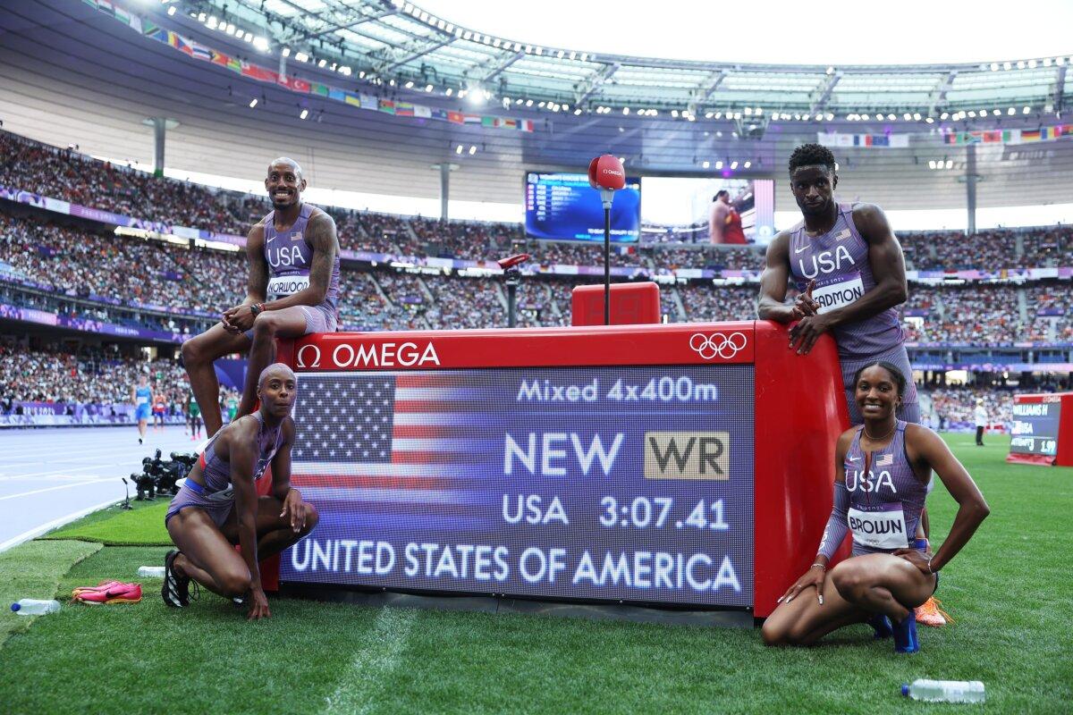 Vernon Norwood, Shamier Little, Kaylyn Brown and Bryce Deadmon of Team United States celebrate after breaking the world record during the 4 x 400m Relay Mixed Round 1 on day seven of the Olympic Games Paris 2024 at Stade de France in Paris on August 2, 2024. (Michael Steele/Getty Images)