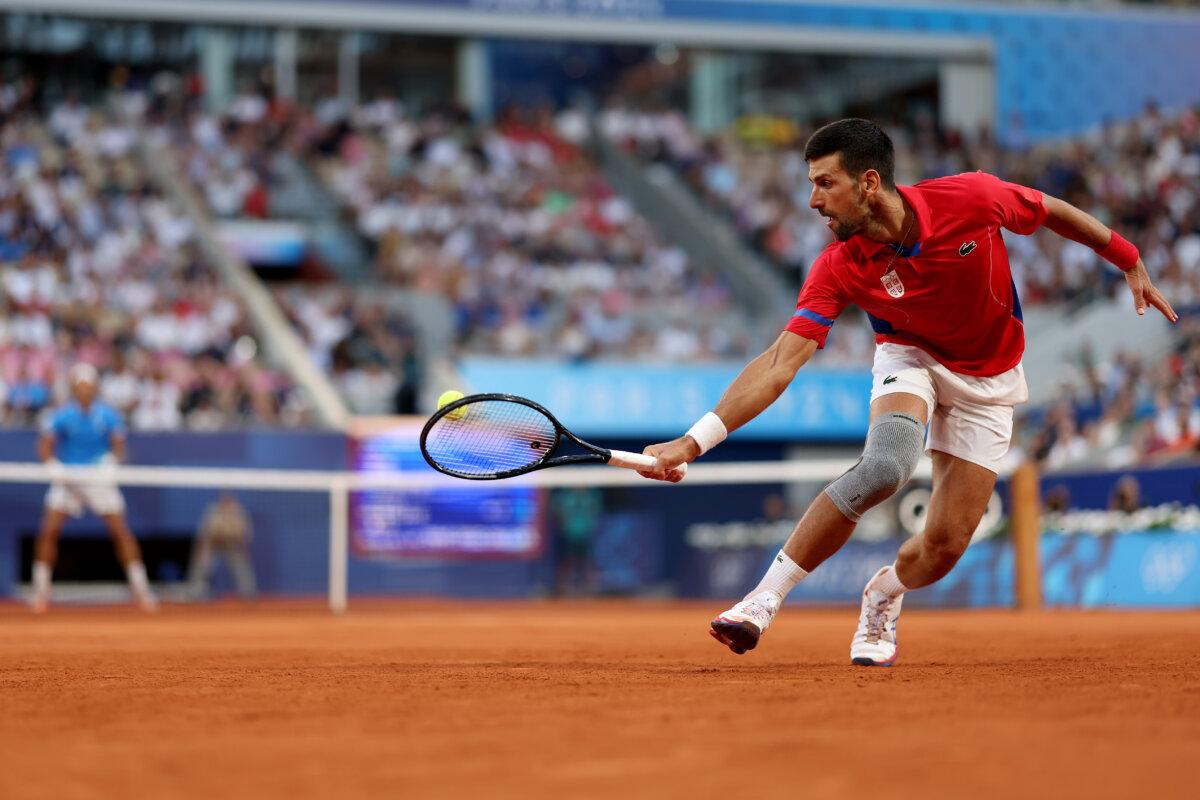 Novak Djokovic of Serbia plays a backhand during the Tennis Men's Singles Semifinal match against Lorenzo Musetti of Italy on day seven of the Olympic Games Paris 2024 at Roland Garros in Paris on August 2, 2024. (Clive Brunskill/Getty Images)