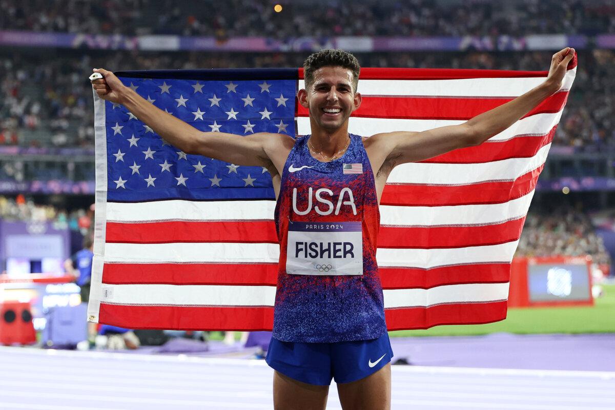 PARIS, FRANCE - AUGUST 02: Bronze medalist Grant Fisher of Team United States celebrates after the Men's 10,000m Final on day seven of the Olympic Games Paris 2024 at Stade de France in Paris on August 02, 2024. (Photo by Christian Petersen/Getty Images)