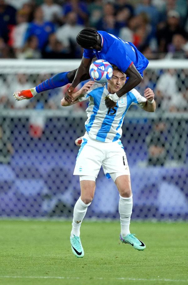 Luciano Gondou (15) of Team Argentina and Castello Lukeba (2) of Team France battle for the ball during the Men's Quarterfinal match between France and Argentina during the Olympic Games Paris 2024 in Bordeaux, France, on Aug. 2, 2024. (Juan Manuel Serrano Arce/Getty Images)