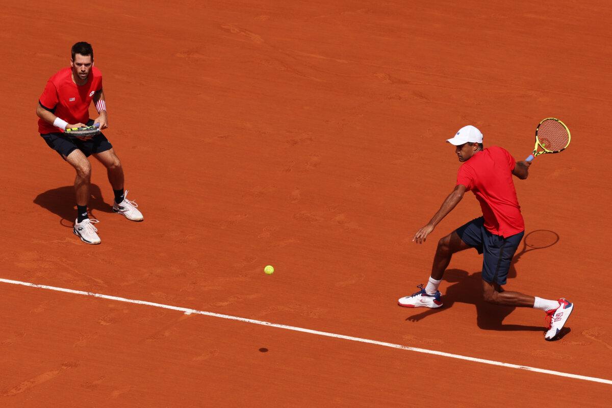 Rajeev Ram of Team United States plays a forehand as he plays with Austin Krajicek of Team United States during the Tennis Men's Doubles Gold Medal match against Matthew Ebden and John Peers of Team Australia on day eight of the Olympic Games Paris 2024 at Roland Garros in Paris on August 3, 2024. (Clive Brunskill/Getty Images)