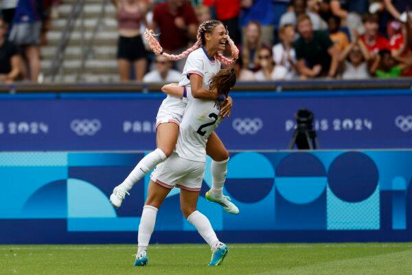 Trinity Rodman of the United States, top, celebrates after scoring the opening goal during the quarterfinal women's soccer match between the United States and the Japan at the Parc des Princes at the 2024 Summer Olympics in Paris on Aug. 3, 2024. (Aurelien Morissard/AP Photo)