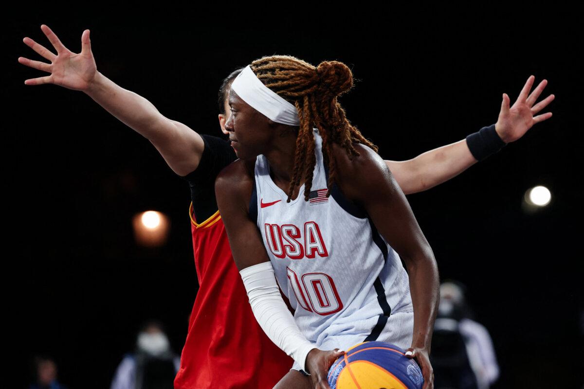 US' #10 Rhyne Howard holds the ball in the women's 3x3 basketball play-in games during the Paris 2024 Olympic Games at La Concorde in Paris on August 3, 2024. (David Gray/AFP via Getty Images)