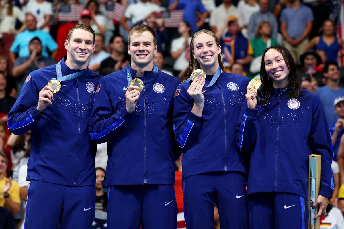 Gold Medalists Ryan Murphy, Nic Fink, Gretchen Walsh, and Torri Huske of Team United States pose on the podium during the Swimming medal ceremony after the Mixed 4x100m Medley Relay Final on day eight of the Olympic Games Paris 2024 at Paris La Defense Arena in Nanterre, France on August 03, 2024. (Quinn Rooney/Getty Images)
