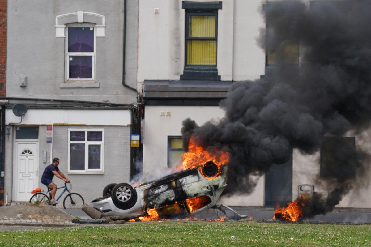 Starmer Condemns Violence as Unrests Continue Across the UK 2 A car burns after being overturned during an anti-immigration protest in Middlesbrough, England, on Aug. 4, 2024. (Owen Humphreys/PA Wire)