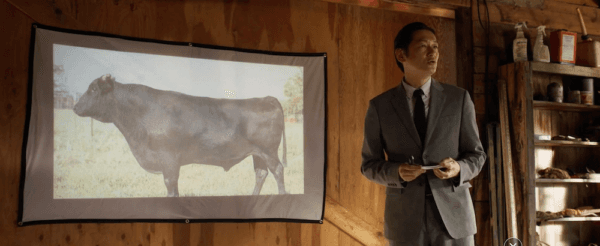 Hideki (Arata Iura) is a Japanese salaryman presenting the reasons a Montana ranch should switch up their cow population for big profits, in "Tokyo Cowboy." (Salaryman Films LLC)