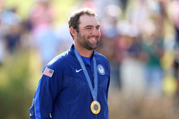 Gold medalist Scottie Scheffler of Team United States poses on the podium at the Olympic Games Paris 2024 at Le Golf National in Paris, on Aug. 4, 2024. (Andrew Redington/Getty Images)