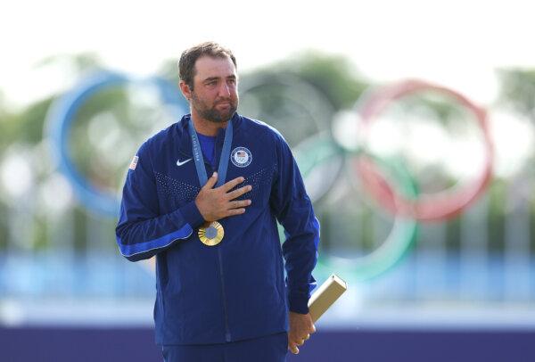 Gold medalist Scottie Scheffler of Team United States reacts on the podium during the men's individual stroke play medal ceremony on day nine of the Olympic Games Paris 2024 at Le Golf National in Paris, France, on Aug. 4, 2024. (Andrew Redington/Getty Images)
