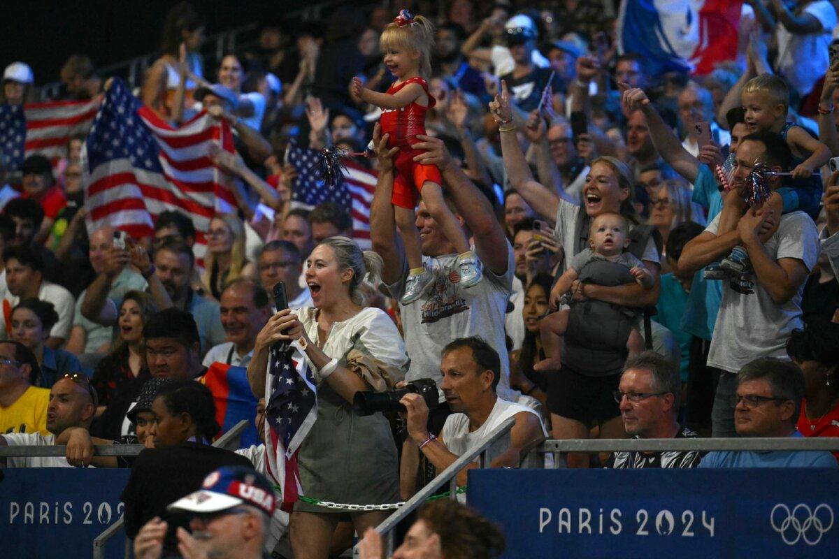 Fans of Team USA's Sarah Ann Hildebrandt celebrate her win over Mongolia's Otgonjargal Dolgorjav in their women's freestyle 50kg wrestling semi-final match at the Champ-de-Mars Arena during the Olympic Games in Paris on Aug. 6, 2024. (Luis Robayo/AFP via Getty Images)