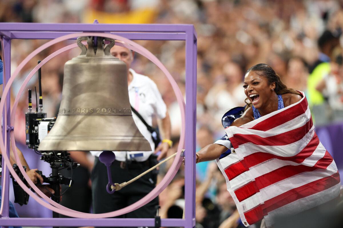 Gold medalist Gabrielle Thomas of Team United States celebrates by ringing the bell after winning the Women's 200m Final on day eleven of the Olympic Games at Stade de France in Paris on Aug. 6, 2024. (Michael Steele/Getty Images)
