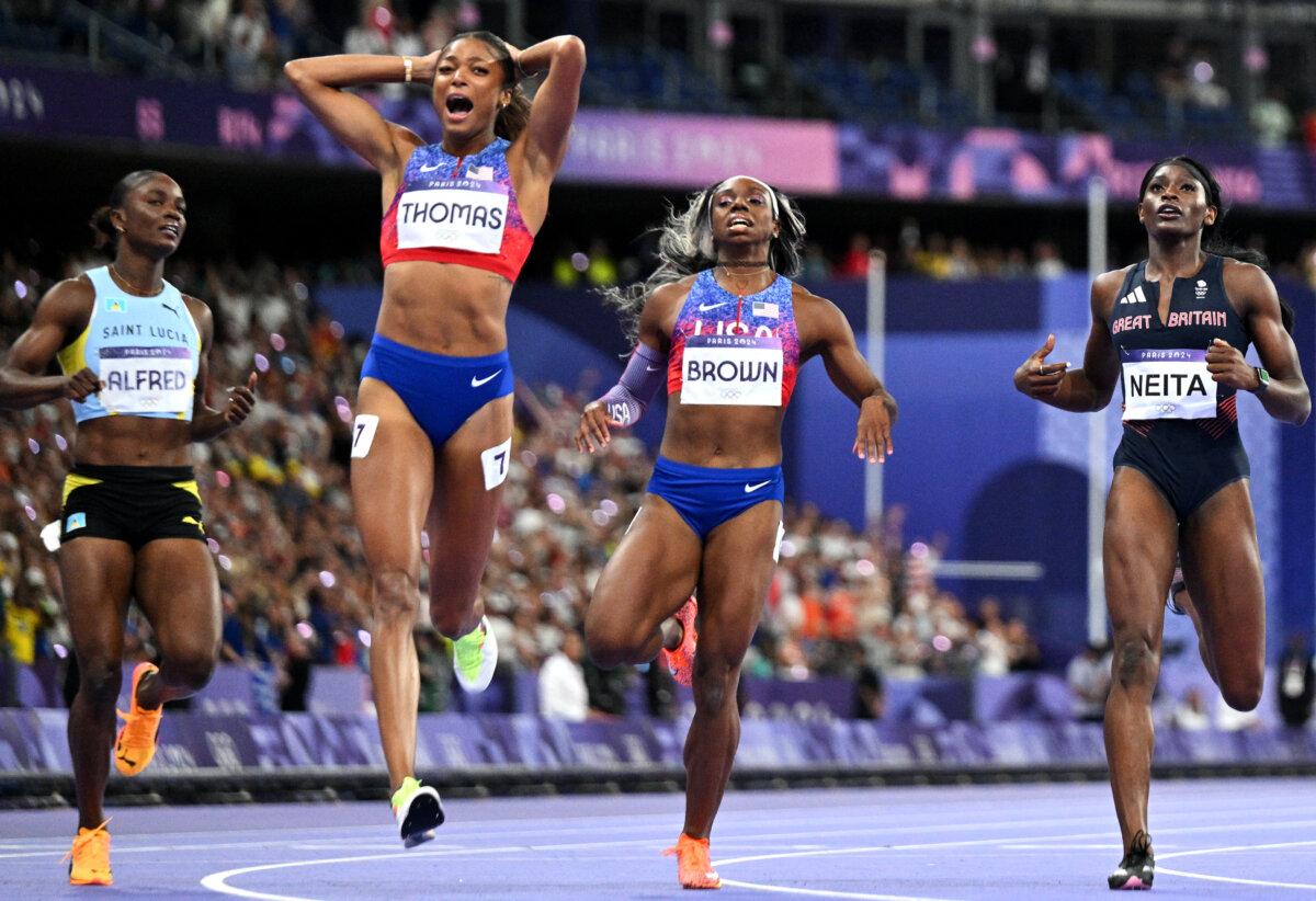Team USA's Gabby Thomas (C) celebrates winning the women's 200m final at the Olympic Games at Stade de France in Saint-Denis, north of Paris, on Aug. 6, 2024. (Jewel Samad/AFP via Getty Images)