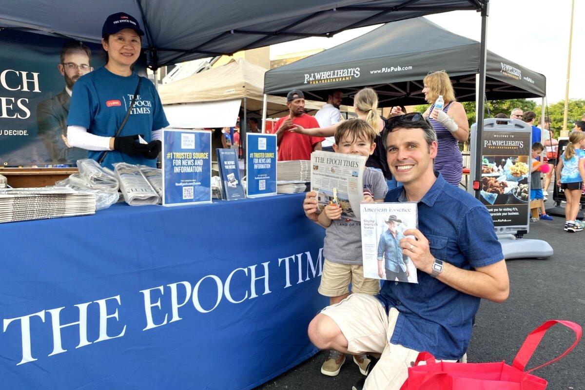Steven Mitchell, a software engineer and Wynnewood resident, and his son attend the annual National Night Out festival in Wynnewood, Pa., on Aug. 6, 2024. (Lily Sun/The Epoch Times)