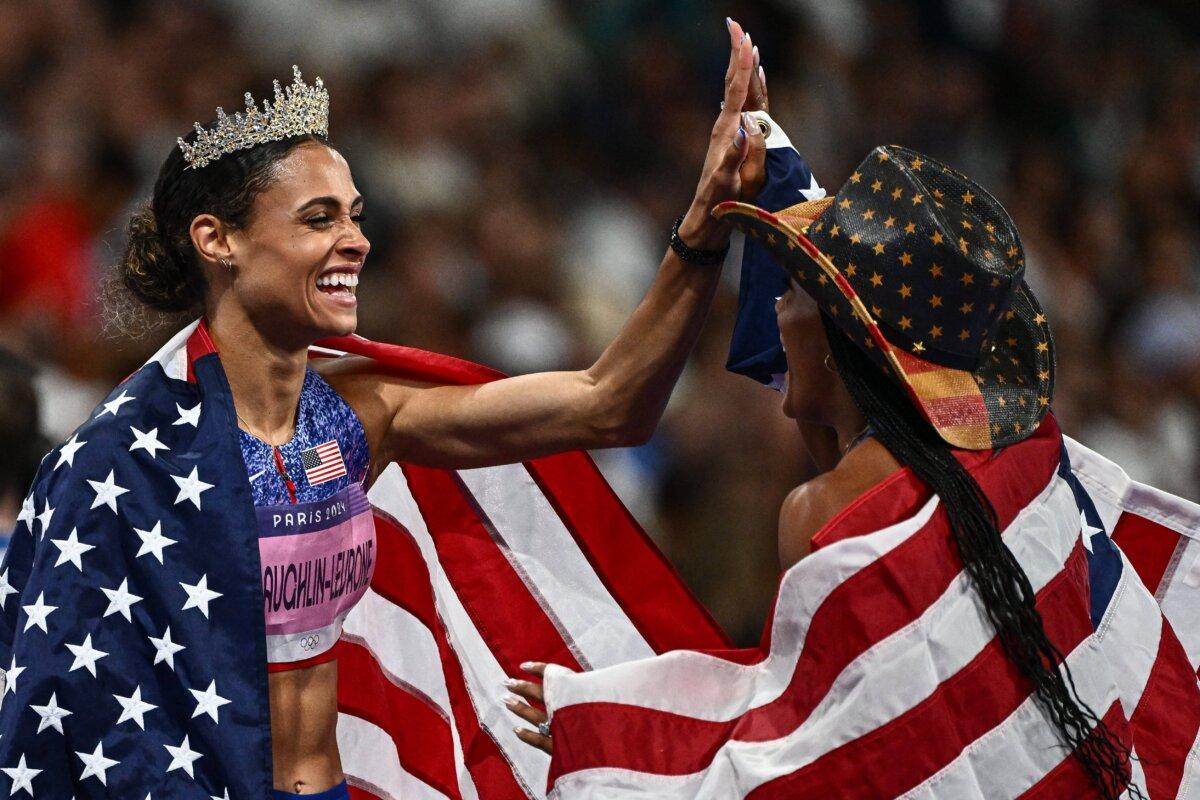 Women's 400m gold medalist Sydney McLaughlin-Levrone of Team United States celebrates with women's long jump gold medalist Tara Davis-Woodhall of Team United States at Stade de France in Paris on Aug. 8, 2024. (Hannah Peters/Getty Images)