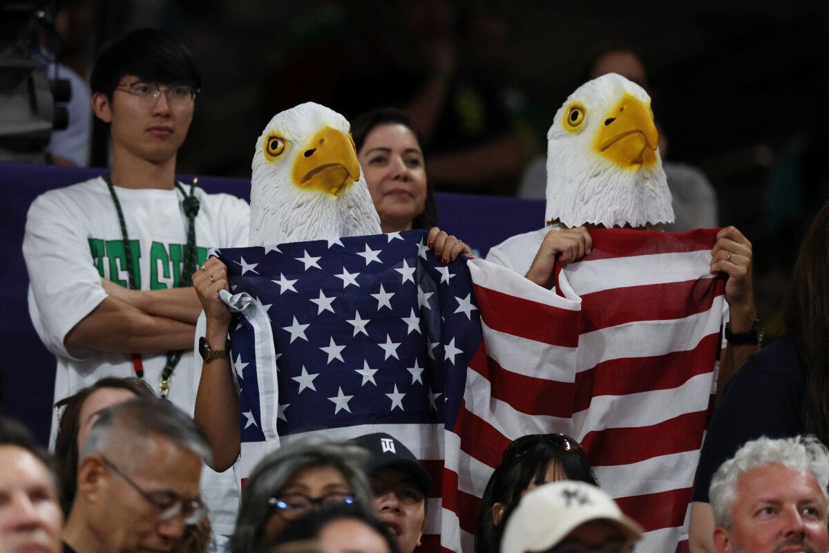 Fans wearing eagle masks wave a Team United States flag during a women's semifinals match on day 13 of the Olympic Games at Paris Arena in Paris on Aug. 8, 2024. (Lintao Zhang/Getty Images)