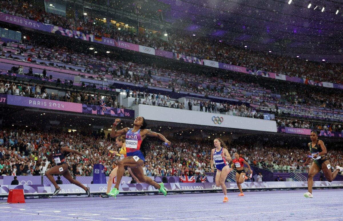 Sha'carri Richardson of Team United States crosses the finish line to win the gold medal in the women's 4x100-meter relay final on day 14 of the Olympic Games at Stade de France in Paris on Aug. 9, 2024. (Michael Steele/Getty Images)