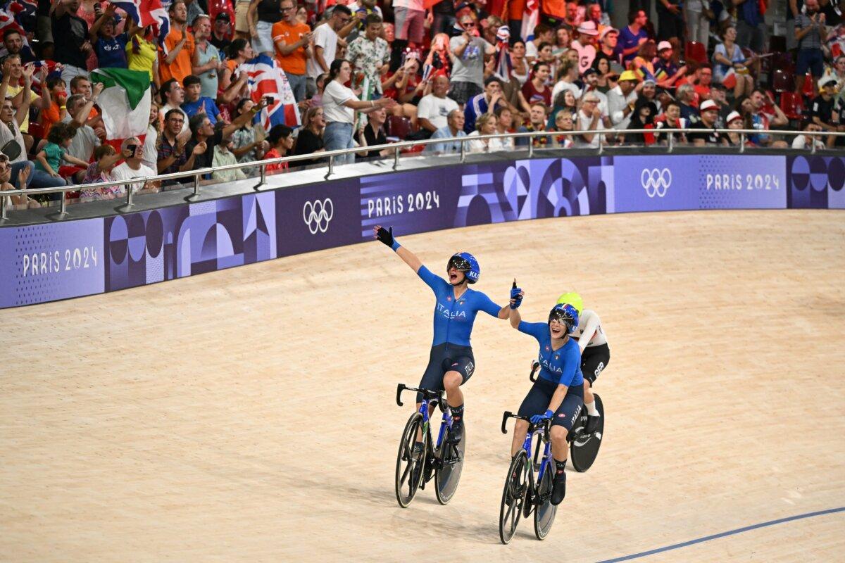 Italy's Chiara Consonni and Italy's Vittoria Guazzini celebrate after winning the women's track cycling madison final of the Paris 2024 Olympic Games at the Saint-Quentin-en-Yvelines National Velodrome in Montigny-le-Bretonneux, south-west of Paris, on Aug. 9, 2024. (Sebastien Bozon/AFP via Getty Images)