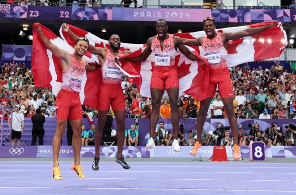 Jerome Blake, Aaron Brown, Andre De Grasse, and Brendon Rodney of Team Canada celebrate winning the gold medal after competing in the men's 4x100m relay final on day 14 of the Olympic Games at Stade de France in Paris on Aug. 9, 2024. (Michael Steele/Getty Images)