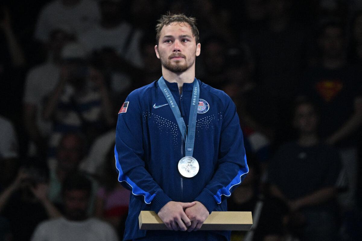 Silver medallist Spencer Richard Lee of Team United States poses with his medal at the presentation ceremony for the men's freestyle 57 kg wrestling event at the Champ-de-Mars Arena during the Paris 2024 Olympic Games, in Paris on Aug. 9, 2024. (Punit Paranjpe/AFP via Getty Images)