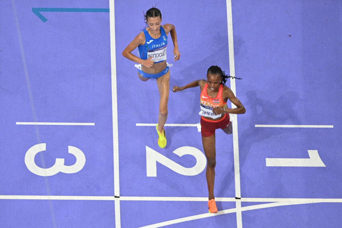 Kenya's Beatrice Chebet crosses the finish line ahead of Italy's Nadia Battocletti in the women's 10,000-meter final of the athletics event at the Paris 2024 Olympic Games at Stade de France in Saint-Denis, north of Paris, on Aug. 9, 2024. (Antonin Thuillier/AFP via Getty Images)