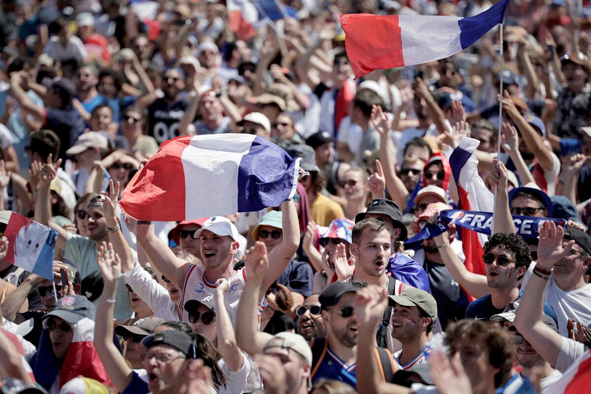 Supporters watch the men's volleyball gold medal match between France and Poland during the Paris 2024 Olympic Games in the Nations Park at La Villette, in Paris on Aug. 10, 2024. (Stephane De Sakutin/AFP via Getty Images)