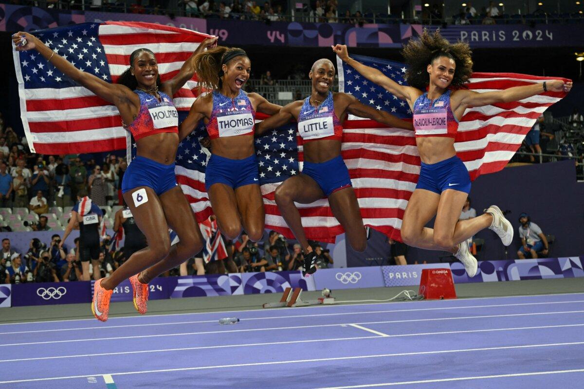 Gold medallists (L-R) Alexis Holmes, Gabby Thomas, Shamier Little, and Sydney McLaughlin-Levrone celebrate winning the women's 4x400m relay final of the athletics event at the Paris 2024 Olympic Games at Stade de France in Saint-Denis, north of Paris, on Aug. 10, 2024. (Andrej Isakovic/ AFP via Getty Images)