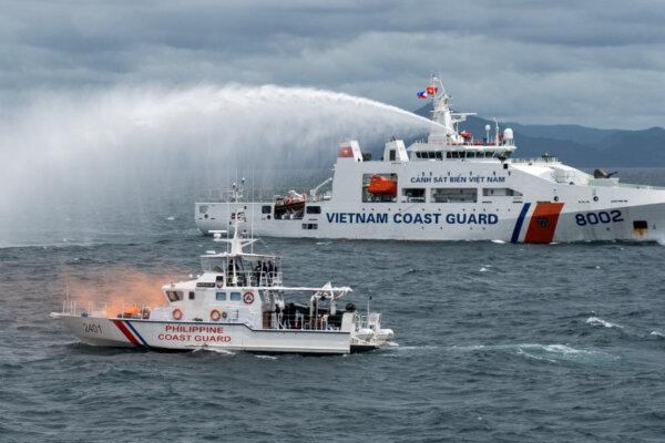 A Vietnamese coast guard ship fires a water cannon during a joint maritime exercise between the Philippine coast guard and the Vietnamese coast guard, in the waters of the Philippines, on Aug. 9, 2024. (Lisa Marie David/Reuters)