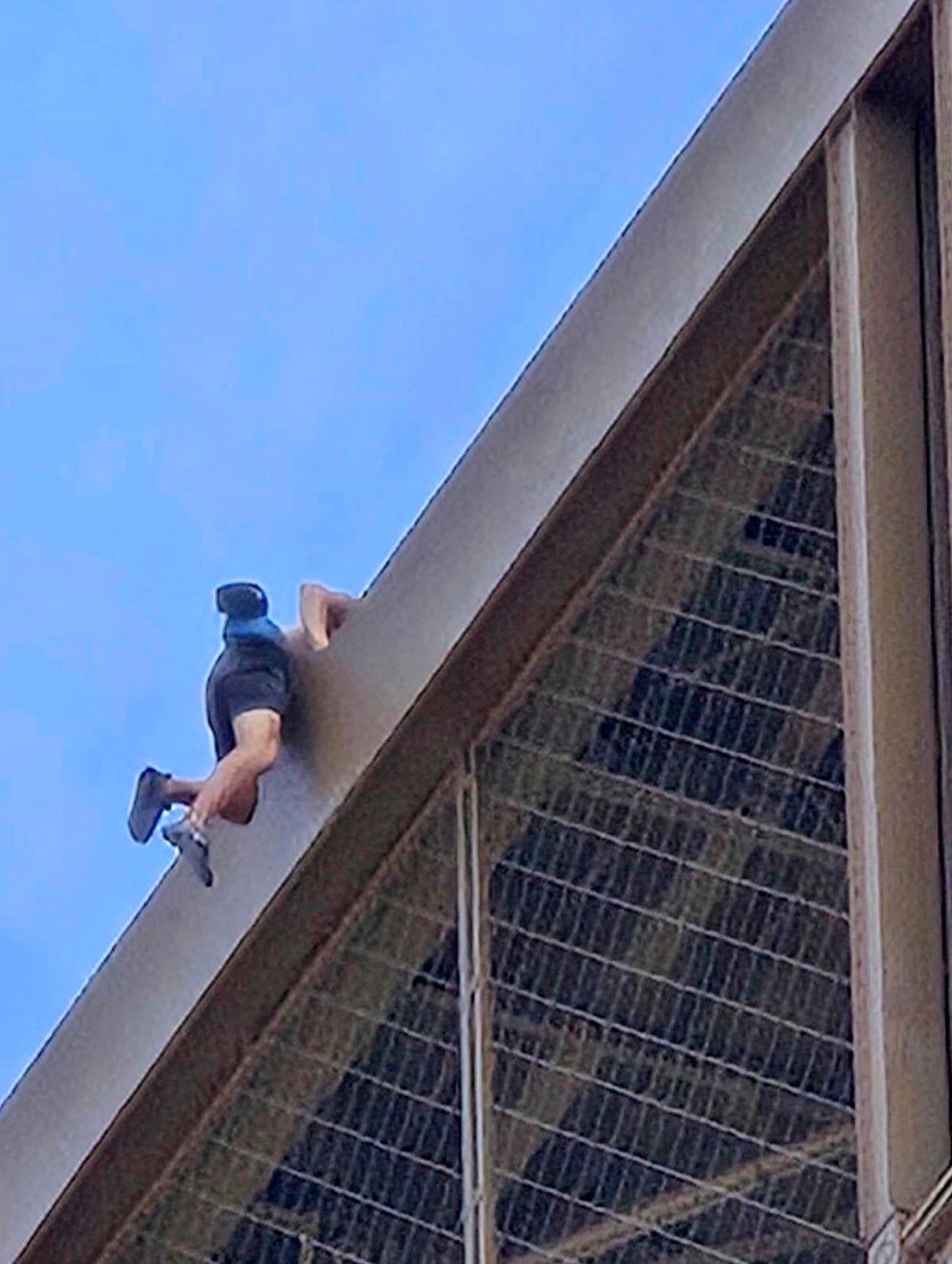 A man climbs the Eiffel Tower during the 2024 Summer Olympics in Paris on Aug. 11, 2024. (Nickey Worlock via AP)